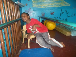 Sitting on the chair on his own.